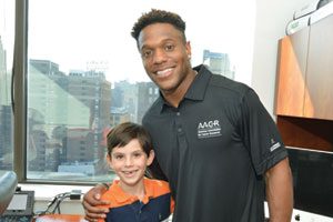 Rodney McLeod meets fan Aidan Silverman at the AACR headquarters in Philadelphia.