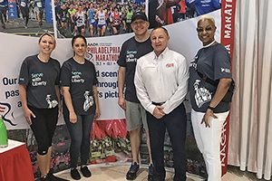 Volunteers from Liberty Mutual Insurance stand with Mitch Stoller (white shirt), AACR Foundation Executive Director and Vice President, Philanthropy, at the Independence Blue Cross Broad Street Run Expo.