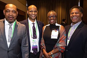 Dr. Olufunmilayo Olopade stands with, from left, Dr. John D. Carpten of the Keck School of Medicine of USC in Los Angeles, Dr. John M. Carethers of the University of Michigan in Ann Arbor, and Dr. Robert A. Winn of the University of Illinois Cancer Center in Chicago. They are attending the AACR Minority Scholar in Cancer Research Awards ceremony at the AACR Annual Meeting 2019 in Atlanta.