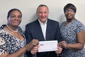 Adrianne Bell and Robin Holts of Club R-K present Mitch Stoller, AACR Foundation chief philanthropic officer and vice president of development, with a check for $1,000.
