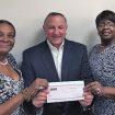 Adrianne Bell and Robin Holts of Club R-K present Mitch Stoller, AACR Foundation chief philanthropic officer and vice president of development, with a check for $1,000.