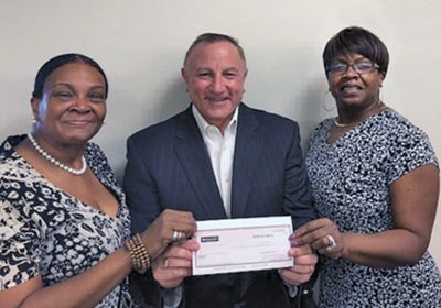 Adrianne Bell and Robin Holts of Club R-K present Mitch Stoller, AACR Foundation chief philanthropic officer and vice president of development, with a check for $1,000.