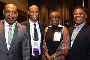 Dr. Olufunmilayo Olopade stands with, from left, Dr. John D. Carpten of the Keck School of Medicine of USC in Los Angeles, Dr. John M. Carethers of the University of Michigan in Ann Arbor, and Dr. Robert A. Winn of the University of Illinois Cancer Center in Chicago. They were attending the AACR Minority Scholar in Cancer Research Awards ceremony at the AACR Annual Meeting 2019 in Atlanta.