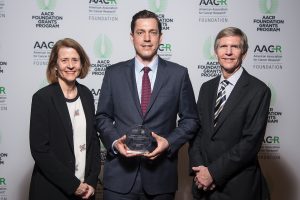 Dr. Benjamin A. Nacev, center, 2019 recipient of the QuadW Foundation-AACR Fellowship for Clinical/Translational Sarcoma Research, stands with Lisa and Mac Tichenor, QuadW founders and parents of Willie Tichenor, who died of osteosarcoma in 2006.