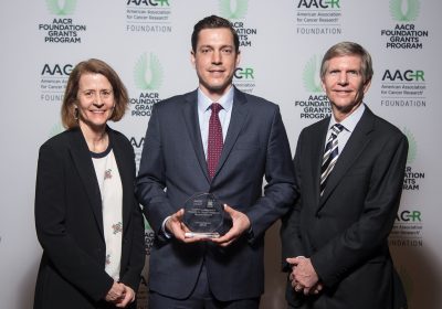 Dr. Benjamin A. Nacev, center, 2019 recipient of the QuadW Foundation-AACR Fellowship for Clinical/Translational Sarcoma Research, stands with Lisa and Mac Tichenor, QuadW founders and parents of Willie Tichenor, who died of osteosarcoma in 2006.