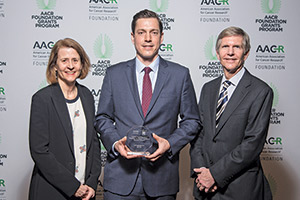  Dr. Benjamin A. Nacev, center, 2019 recipient of the QuadW Foundation-AACR Fellowship for Clinical/Translational Sarcoma Research, stands with Lisa and Mac Tichenor, QuadW founders and parents of Willie Tichenor, who died of osteosarcoma in 2006. 