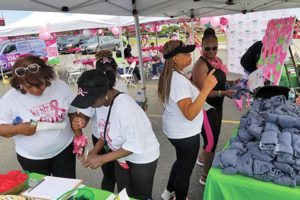 Participants visit the AACR booth at the 3rd annual Sista Strut 3K Breast Cancer Walk, which took place on Saturday, June 15, in Philadelphia. The event raised awareness for breast cancer, with a portion of the proceeds benefiting the AAC